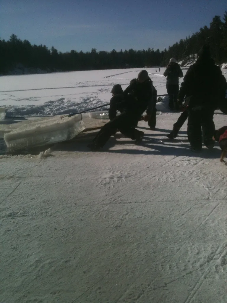 Pulling a large block of ice from the water